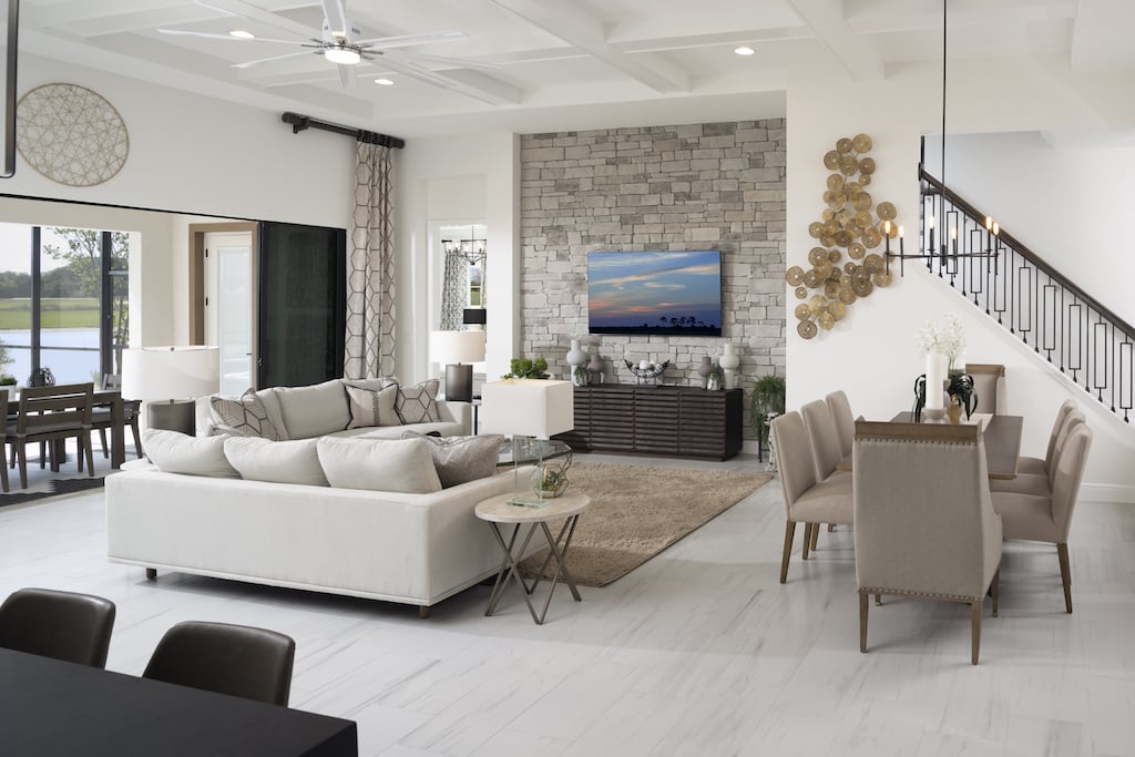 Interior living area with sofas and tv on teh left and dining table ont he right