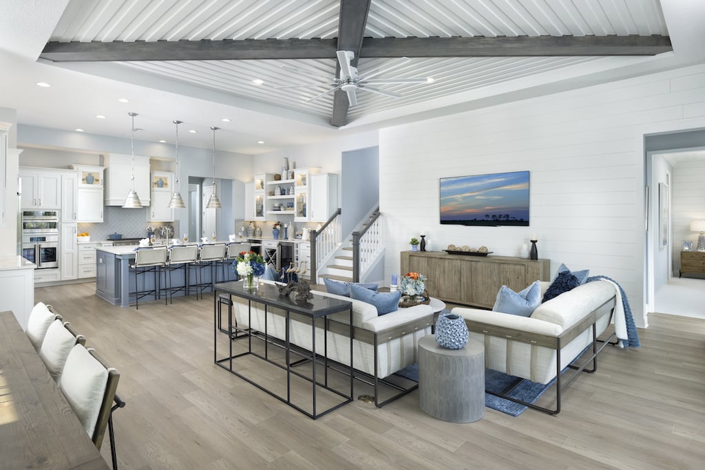 Interior living area with exposed ceiling, open-concept kitchen, and TV and couch area